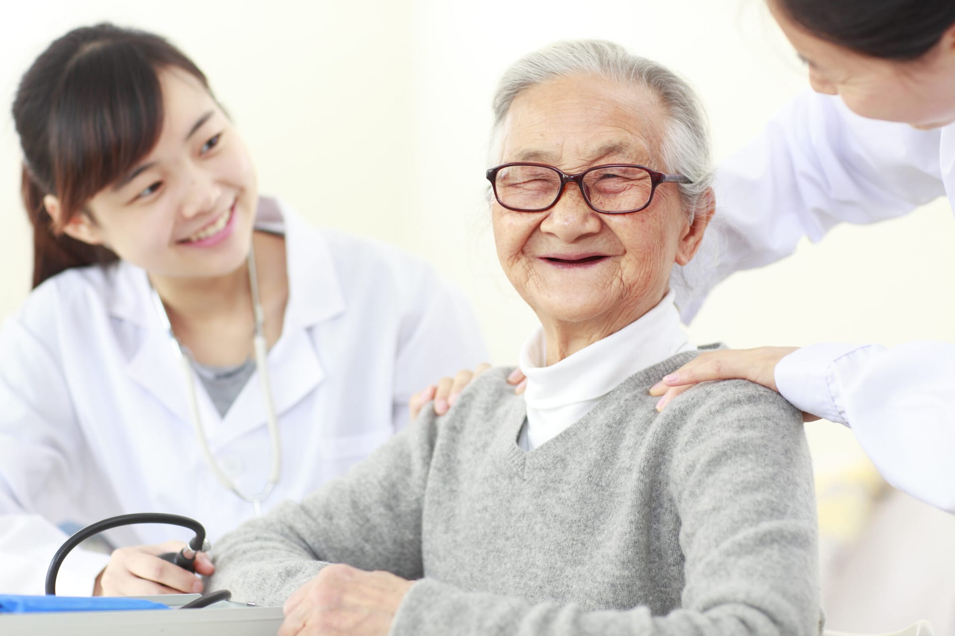 Smiling older man receiving healthcare assistance.